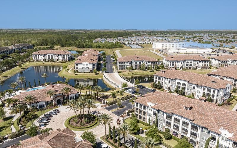 a large building with a pond in front of it