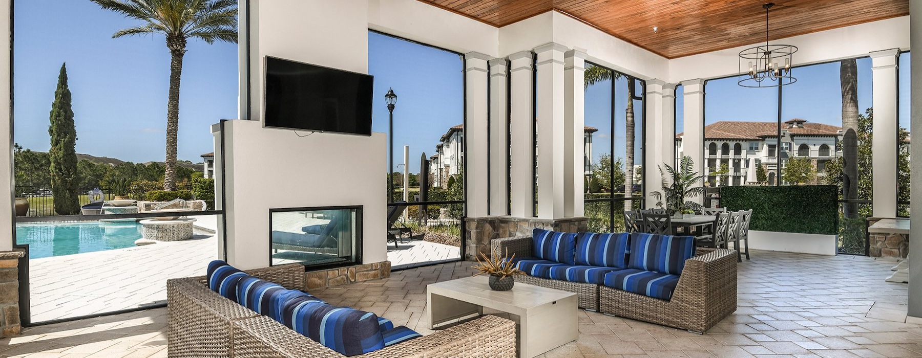 a living room with a pool and a large screen
