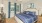 a bedroom with a bed and a fan
